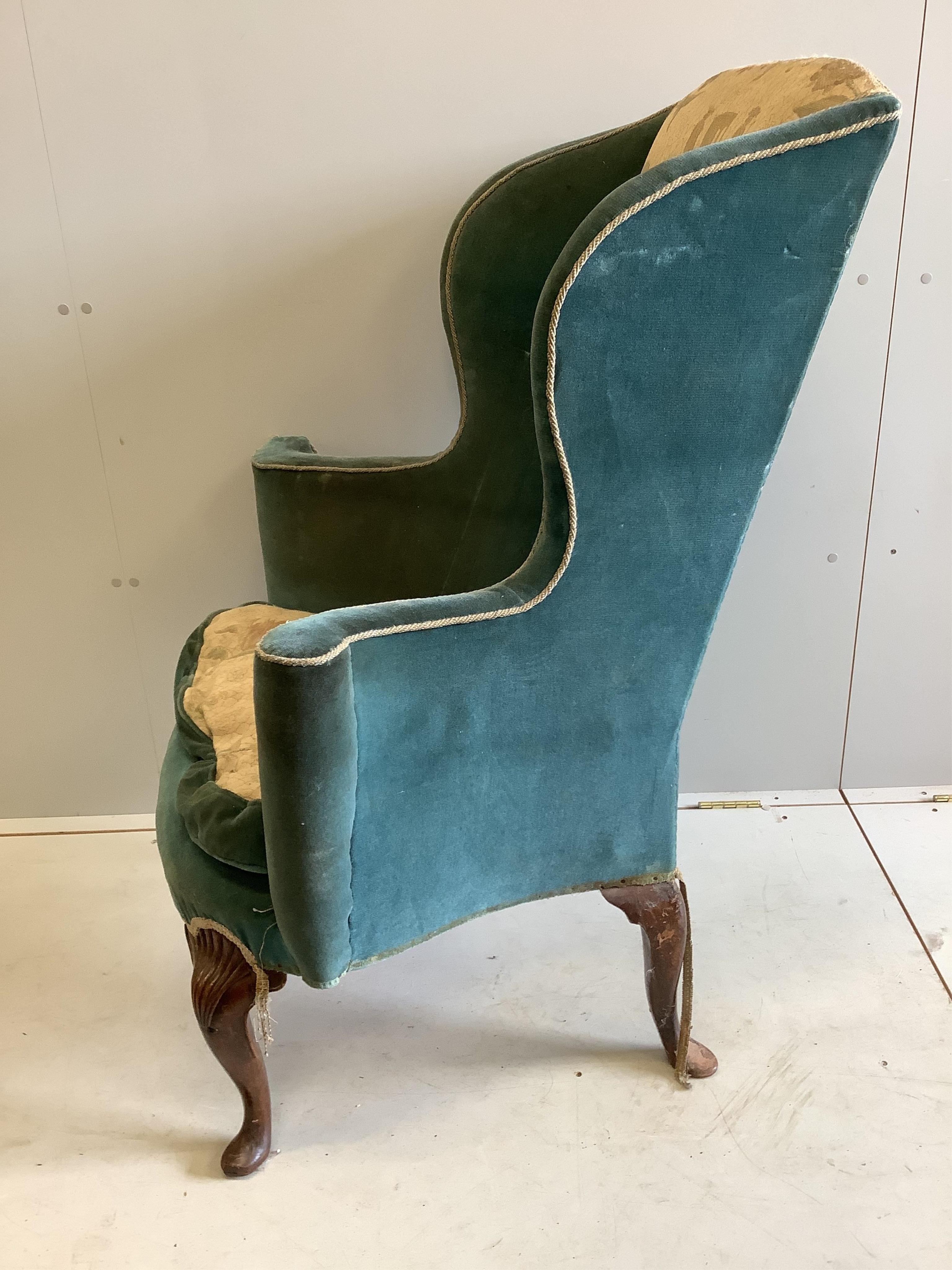 A 19th century Queen Anne style upholstered wing armchair, width 82cm, depth 60cm, height 116cm. Condition - fair